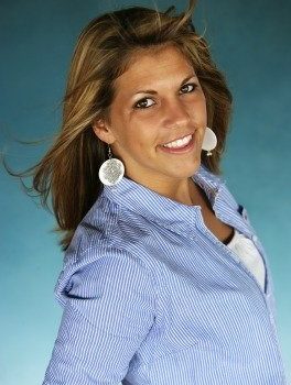 a photo of Erica with a light blue shirt and hair blowing