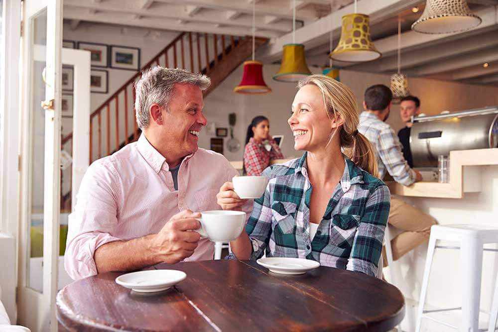 An older couple on a date enjoying a cup of coffee