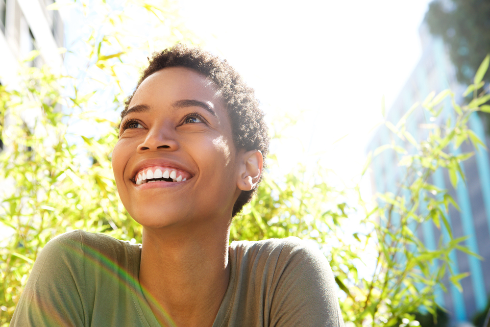 A young woman looking up and smiling