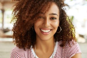 A young woman with beautiful hair smiling