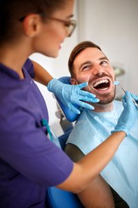 dentist examining man's teeth