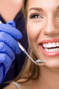 dentist examining woman's teeth