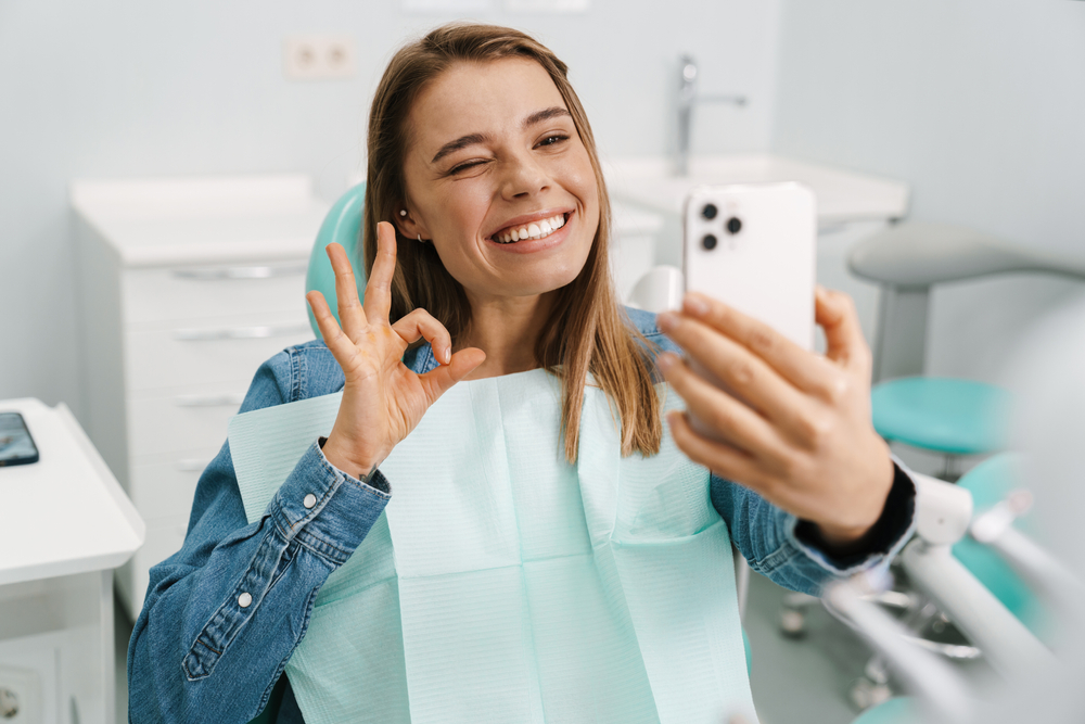 girl taking a selfie in the dental chair