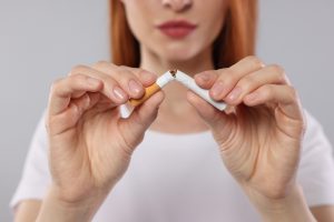 woman breaking cigarette