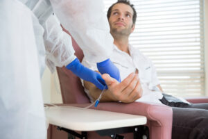 dental assistand helping man with IV sedation 