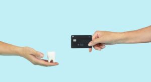 model of tooth and credit card