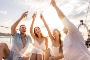 friend holding drinks  up on their boat
