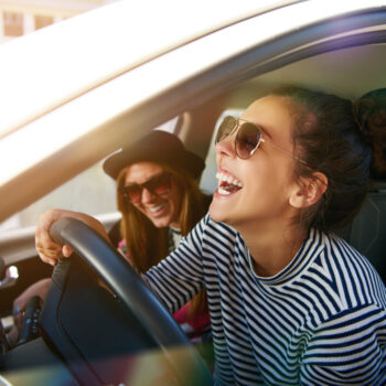 two women in a car laughing