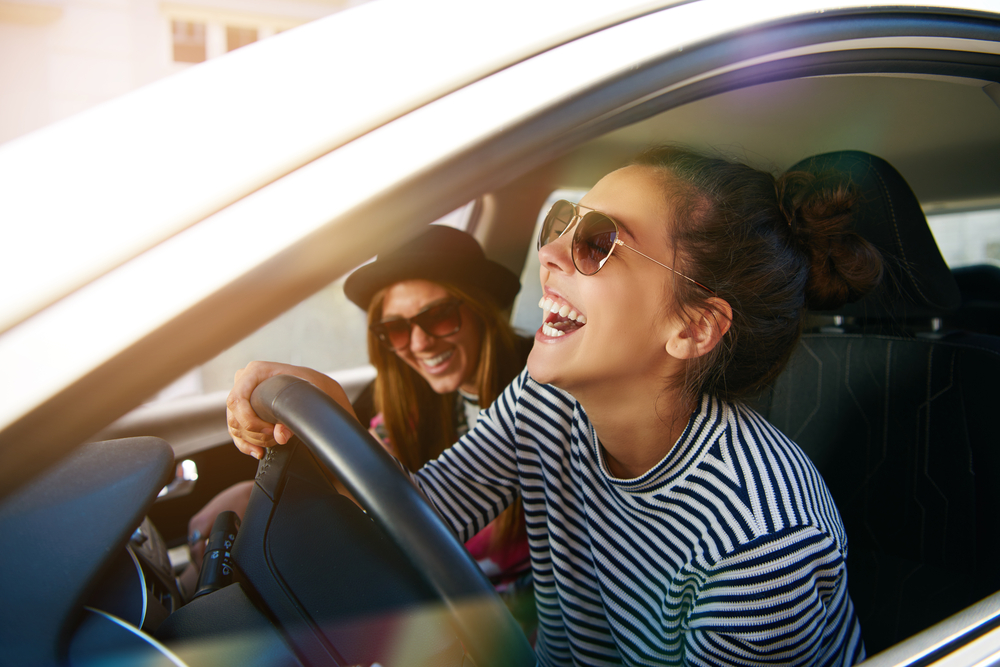 two women in a car laughing