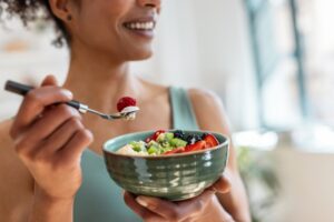 woman eating fruit salad