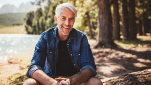 man sitting by a lake